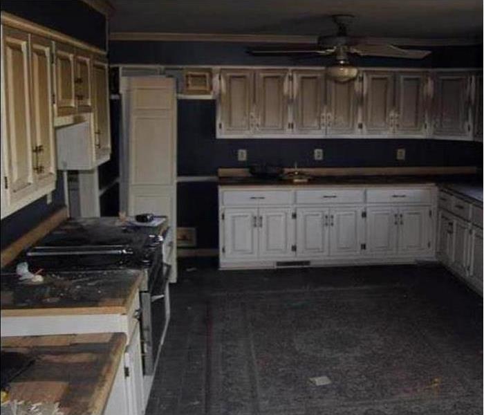 smoke and soot on white kitchen cabinets, ceiling, wall, and floor