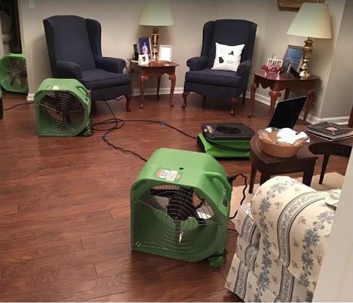 SERVPRO drying equipment in water damaged living room