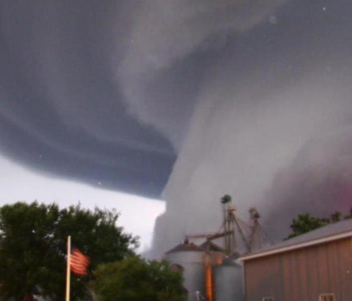 A tornado approaches a farm