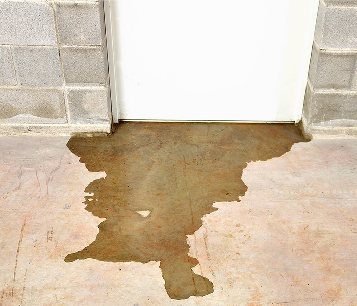 Sewage leaking under a door of the commercial building. 