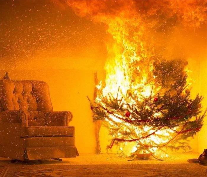 Christmas tree on fire in corner of living room