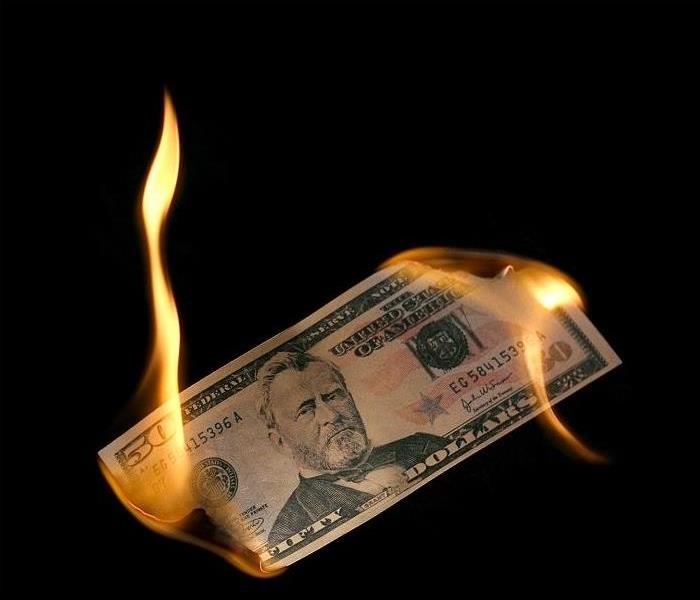 $50 bill being burned at both ends